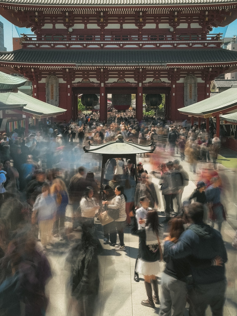Crowds moving through incense smoke at Sensō-ji temple in Tokyo
